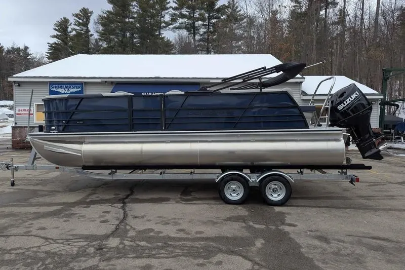 Slide: The Image of 2026 Berkshire 22CL2 LE pontoon boat on trailer, parked outdoors. - 4