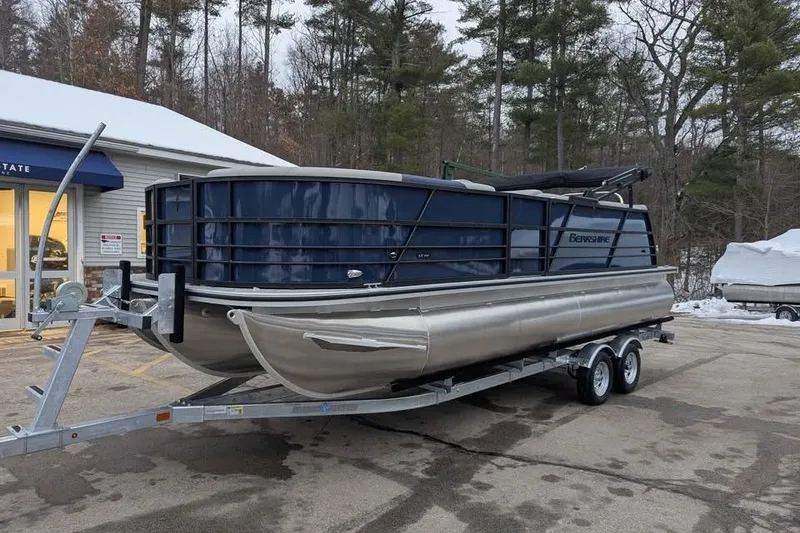 Slide: The Image of 2026 Berkshire 22CL2 LE pontoon boat on trailer, parked outside dealership in winter setting. - 5