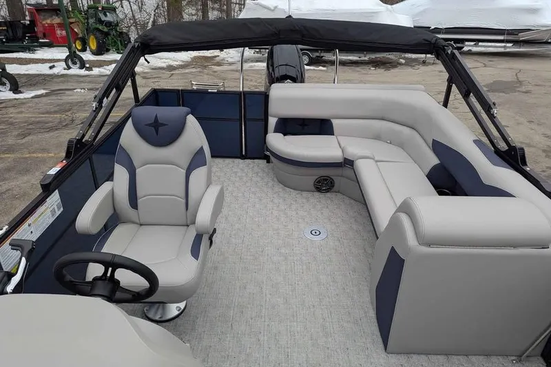 Slide: The Image of 2026 Berkshire 22CL2 LE pontoon boat interior with plush seating and steering console. - 8
