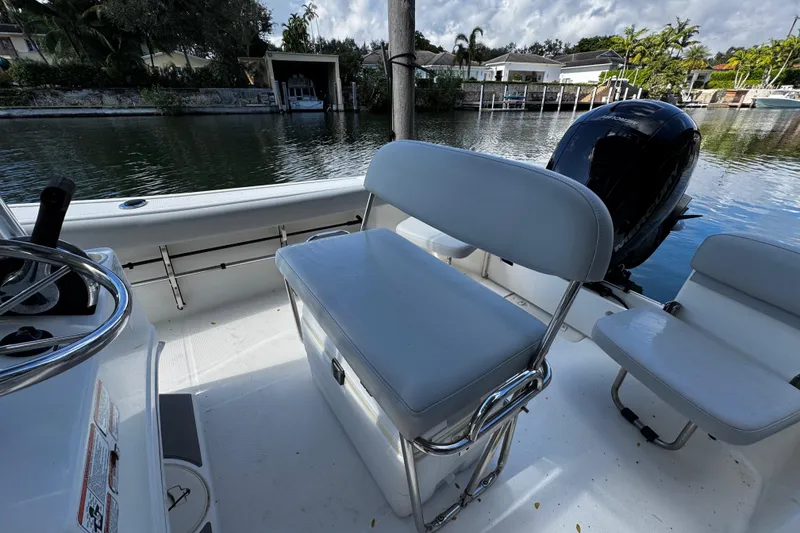 Slide: The Image of 2018 Mako 204 Center Console boat interior with seating and outboard motor. - 10