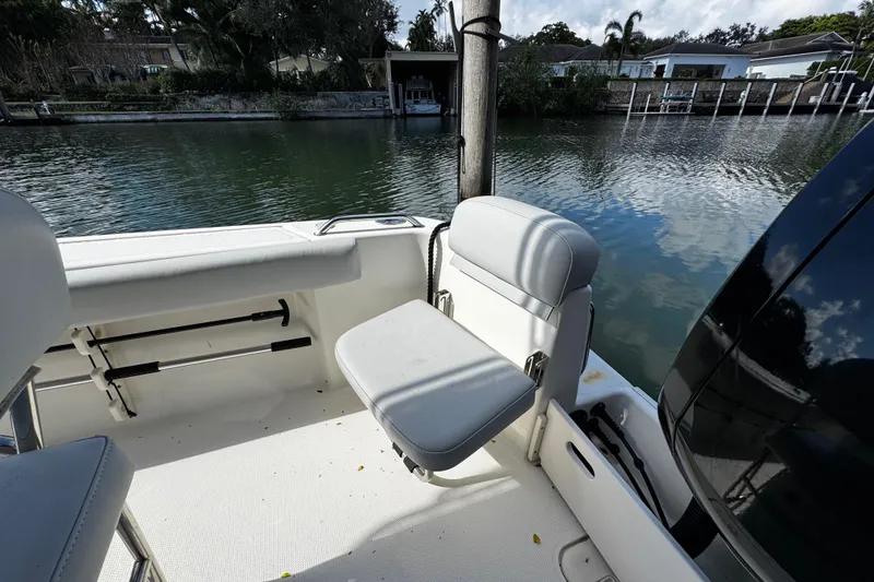 Slide: The Image of 2018 Mako 204 Center Console boat interior with seating by the water. - 12