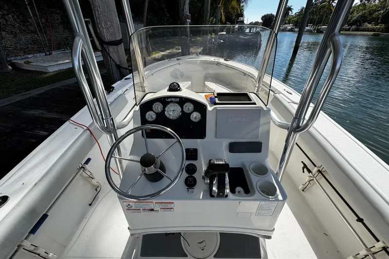 Slide: The Image of 2018 Mako 204 Center Console boat interior with steering wheel and control panel. - 13