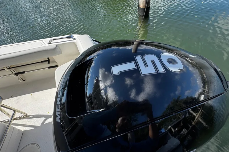Slide: The Image of 2018 Mako 204 Center Console boat with Mercury outboard engine on water. - 17