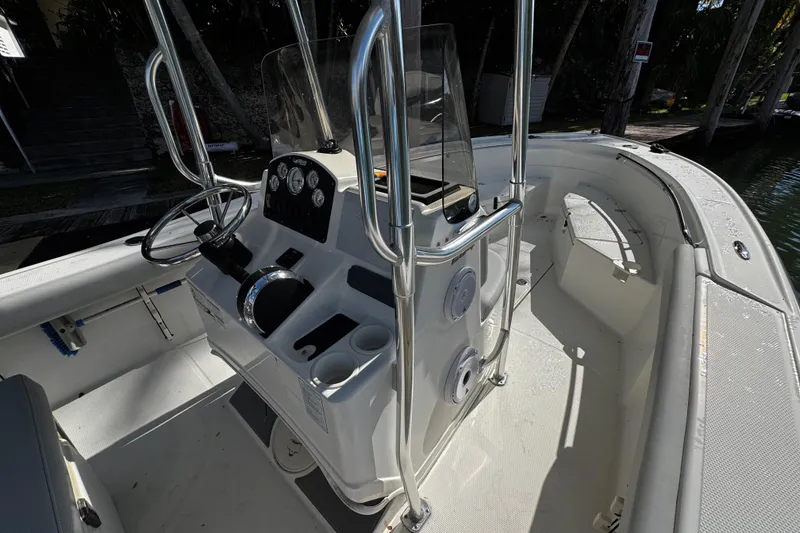 Slide: The Image of 2018 Mako 204 Center Console boat interior with steering wheel and control panel. - 18