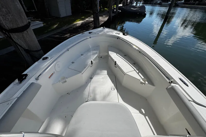 Slide: The Image of 2018 Mako 204 Center Console boat interior, docked by calm water. - 5