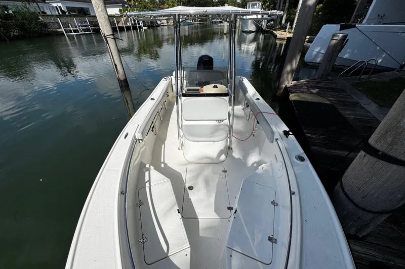 Slide: The Image of 2018 Mako 204 Center Console boat docked on calm water. - 6
