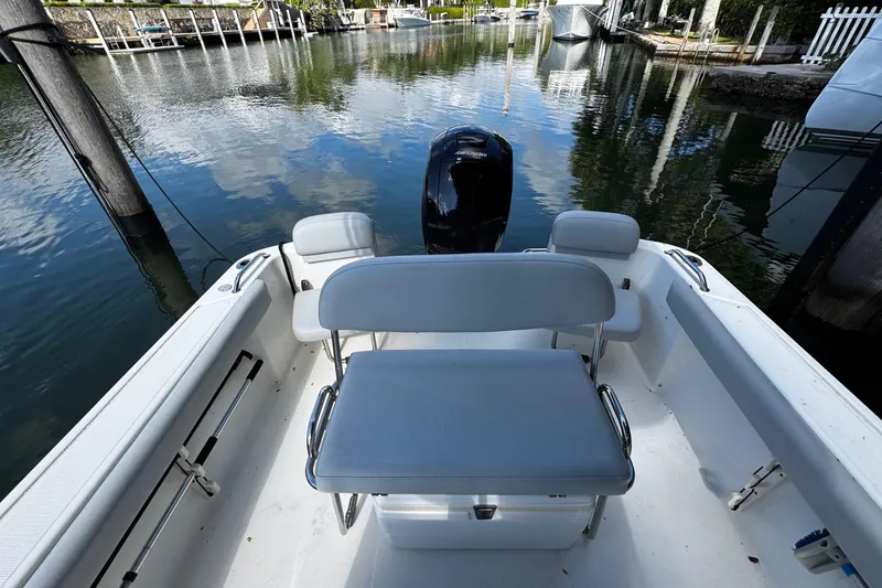 Slide: The Image of 2018 Mako 204 Center Console boat interior with seating and outboard motor. - 9