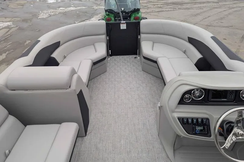 Slide: The Image of 2026 Berkshire 24RFX LE pontoon boat interior with plush seating and modern dashboard. - 11