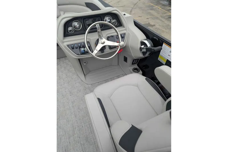 Slide: The Image of Interior of 2026 Berkshire 24RFX LE boat, featuring steering wheel and control panel. - 13