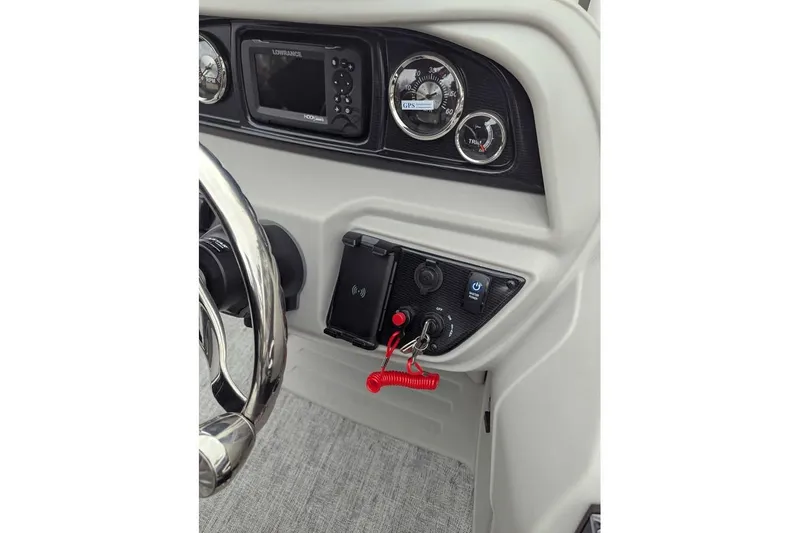 Slide: The Image of Dashboard of 2026 Berkshire 24RFX LE boat with steering wheel and control panel. - 14