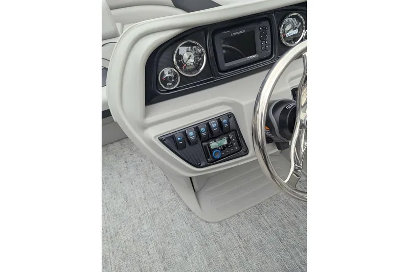 Slide: The Image of 2026 Berkshire 24RFX LE boat dashboard with steering wheel and control panel. - 15