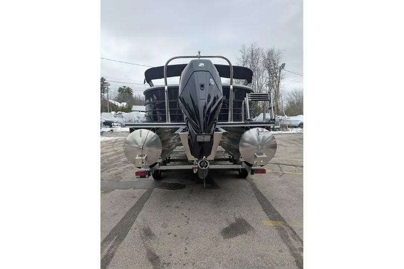 Slide: The Image of 2026 Berkshire 24RFX LE pontoon boat, rear view, parked on pavement. - 3
