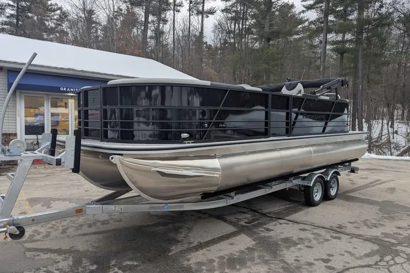 Slide: The Image of 2026 Berkshire 24RFX LE pontoon boat on trailer in snowy outdoor setting. - 6