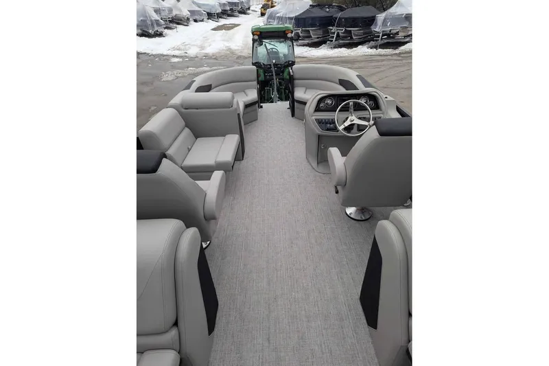 Slide: The Image of 2026 Berkshire 24RFX LE pontoon boat interior with gray seating and steering console. - 9