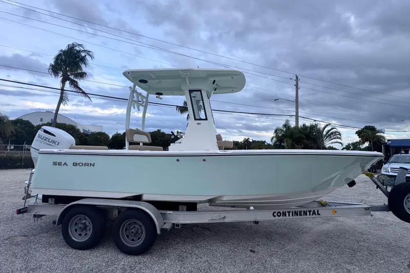 Slide: The Image of 2026 Sea Born LX22 Center Console boat on trailer, parked outdoors. - 1