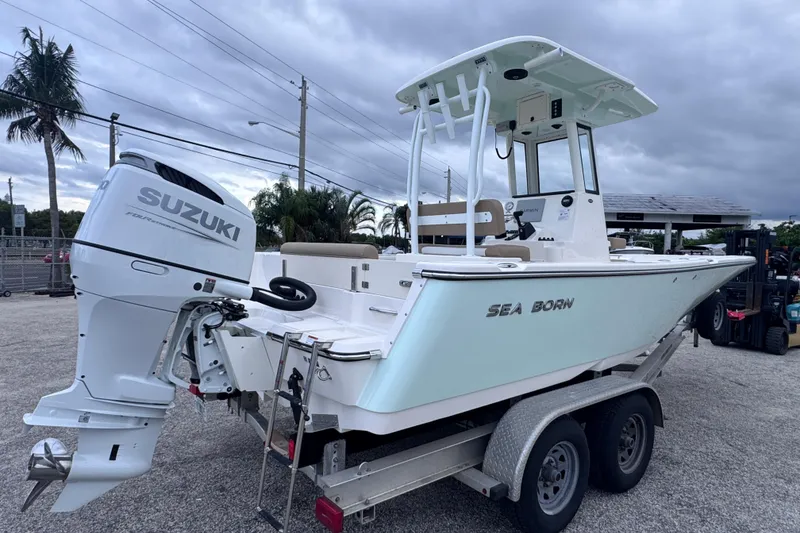 Slide: The Image of 2026 Sea Born LX22 Center Console boat on trailer with Suzuki outboard motor. - 3
