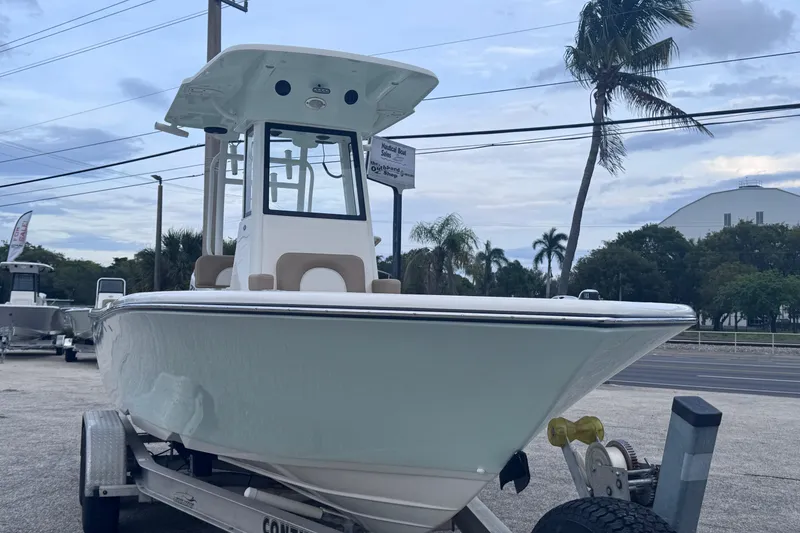Slide: The Image of 2026 Sea Born LX22 Center Console boat on trailer, parked outdoors with palm trees. - 5
