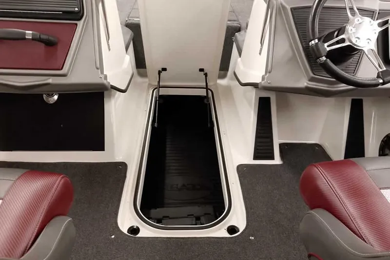 Slide: The Image of 2020 Ranger 1850MS Reata boat interior with open storage compartment and steering wheel. - 21