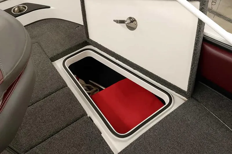 Slide: The Image of 2020 Ranger 1850MS Reata boat storage compartment with open hatch and red interior. - 27