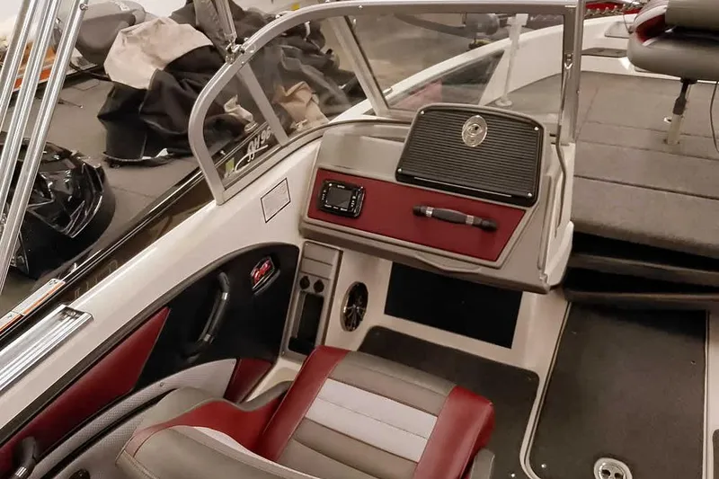 Slide: The Image of 2020 Ranger 1850MS Reata boat interior with red and gray seating and dashboard. - 32