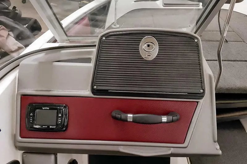 Slide: The Image of 2020 Ranger 1850MS Reata boat dashboard with control panel and storage compartment. - 33