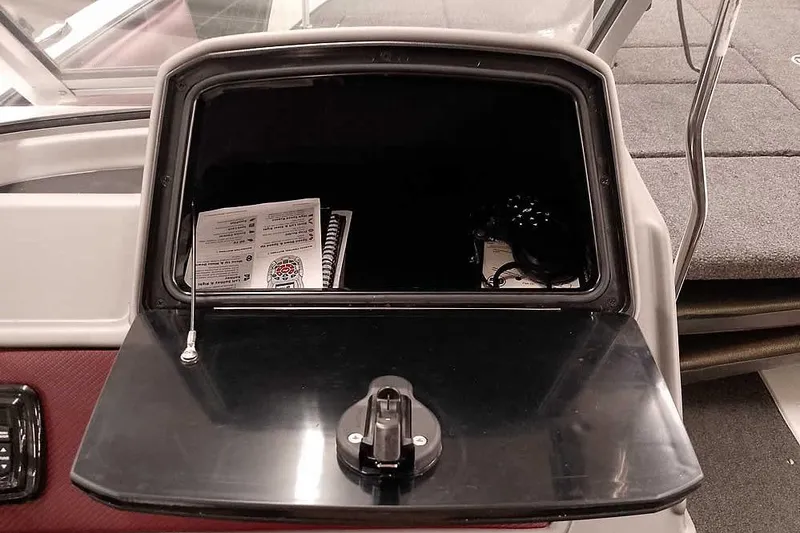 Slide: The Image of Open storage compartment in 2020 Ranger 1850MS Reata boat with manuals and accessories. - 35