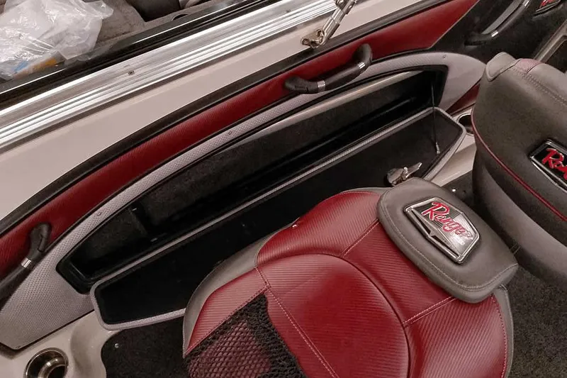 Slide: The Image of 2020 Ranger 1850MS Reata boat interior with red and gray seating and storage compartment. - 44