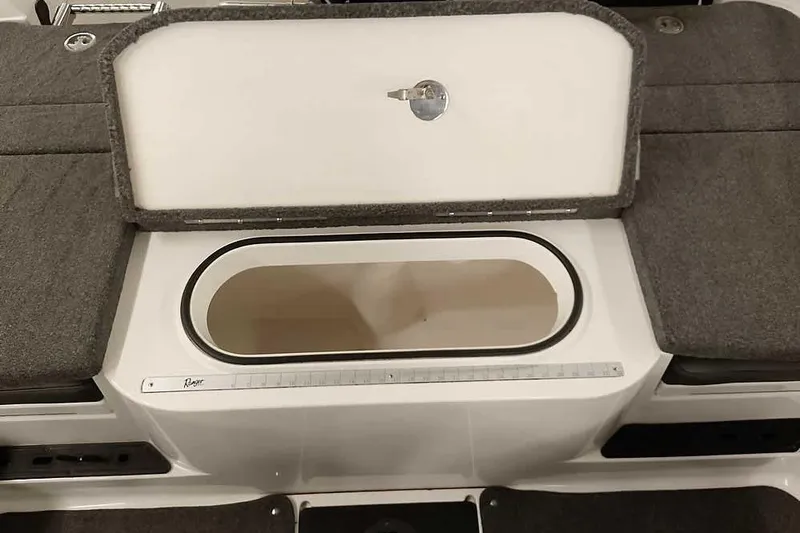 Slide: The Image of 2020 Ranger 1850MS Reata boat storage compartment with open lid and measuring ruler. - 50