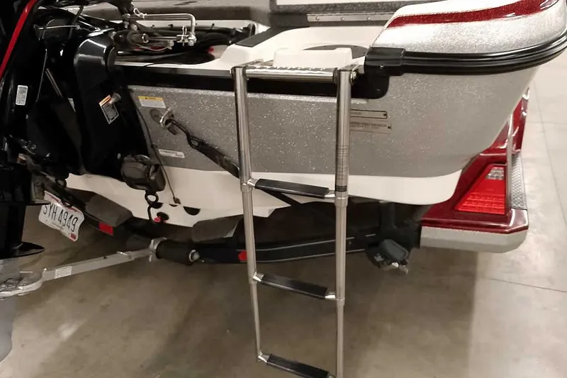 Slide: The Image of 2020 Ranger 1850MS Reata boat with ladder and motor, parked indoors. - 53