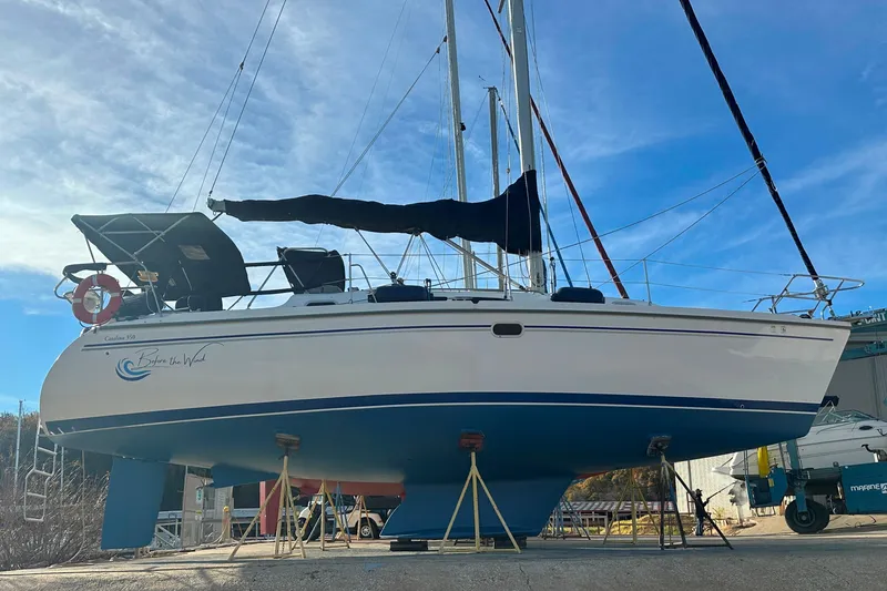 Slide: The Image of Catalina 350 sailboat from 2003 on stands, with blue sky background. - 2