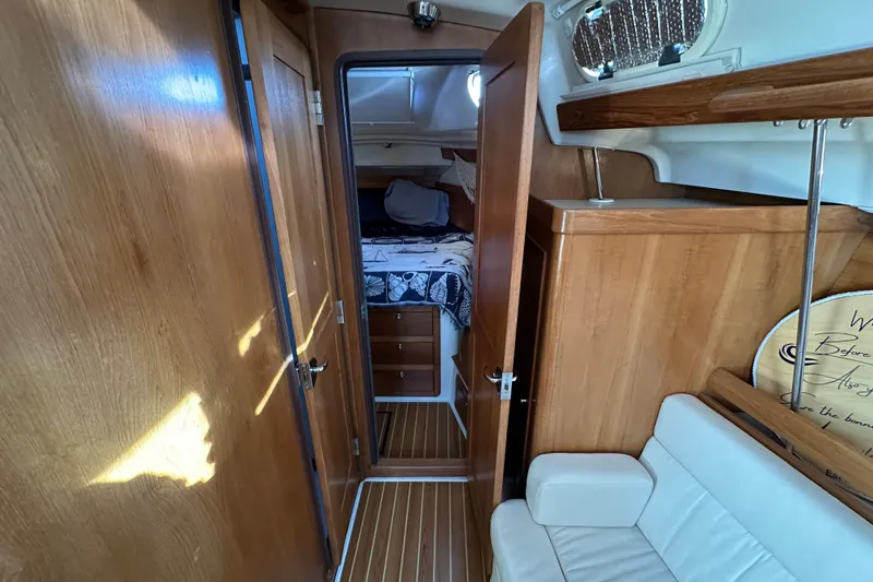 Slide: The Image of Interior of 2003 Catalina 350 sailboat with wooden cabinetry and cozy sleeping area. - 20