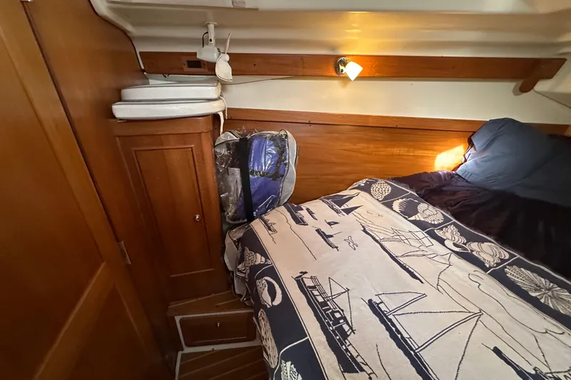 Slide: The Image of Cozy cabin interior of 2003 Catalina 350 sailboat with nautical-themed bedding. - 23