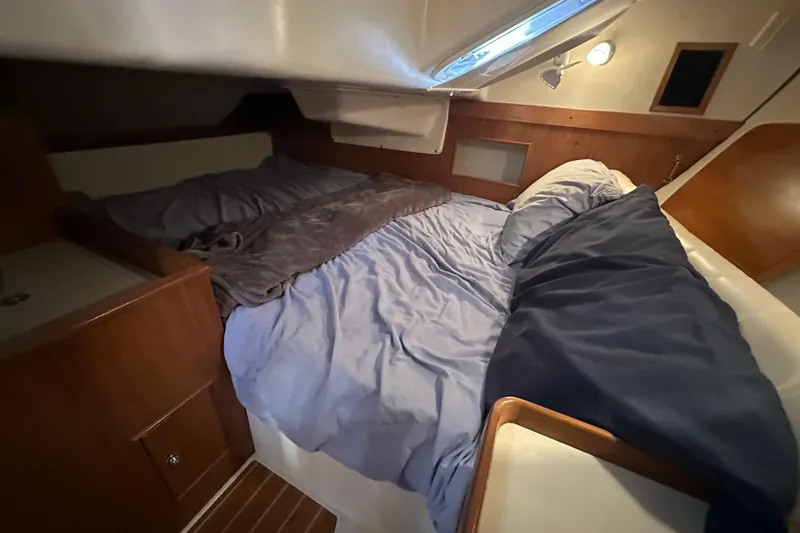 Slide: The Image of Cozy cabin interior of a 2003 Catalina 350 sailboat with a comfortable bed. - 31