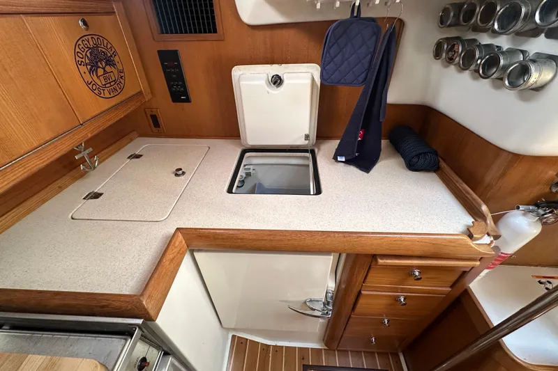 Slide: The Image of 2003 Catalina 350 yacht kitchen with wooden cabinetry and countertop. - 36