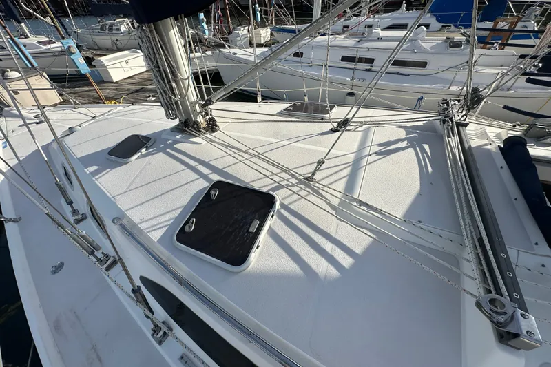 Slide: The Image of 2003 Catalina 350 sailboat deck with rigging and hatches in marina setting. - 4