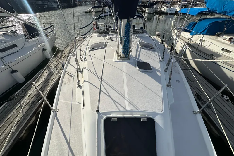 Slide: The Image of Catalina 350 sailboat deck, 2003 model, docked at marina with surrounding boats. - 5