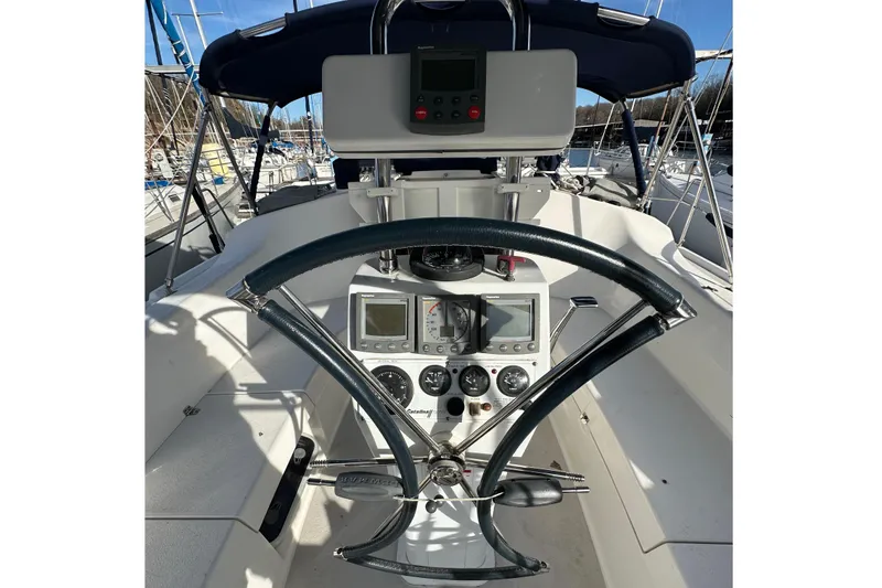 Slide: The Image of Cockpit of 2003 Catalina 350 sailboat with steering wheel and navigation instruments. - 9