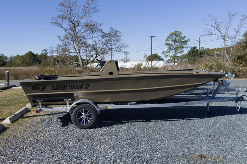Slide: The Image of 2026 G3 Gator Tough 17 CC boat on trailer, parked outdoors. - 5