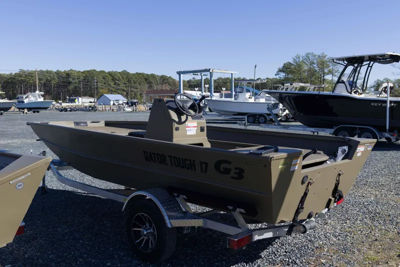 Slide: The Image of 2026 G3 Gator Tough 17 CC boat on trailer in outdoor lot. - 6