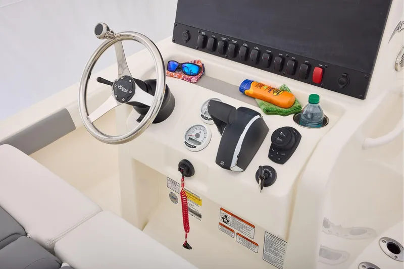 Slide: The Image of Steering console of 2026 Mako 24 APEX boat with controls and accessories. - 29