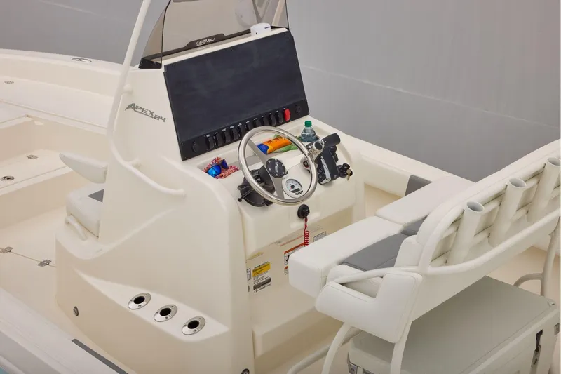 Slide: The Image of 2026 Mako 24 APEX boat console with steering wheel and seating. - 26