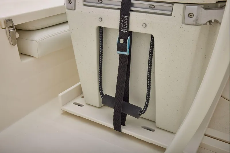 Slide: The Image of Secure storage compartment on 2026 Mako 24 APEX boat with strap and latch. - 24