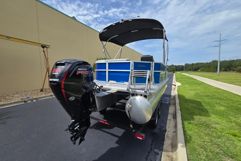 Slide: The Image of 2026 Sun Tracker Party Barge 20 DLX with Mercury Pro XS engine, parked outdoors. - 5