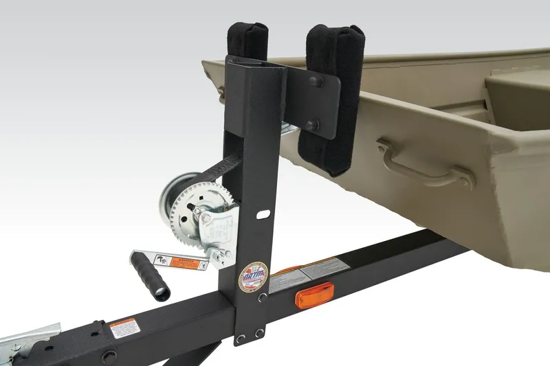 Slide: The Image of 2026 Tracker Grizzly 15 Jon boat on trailer outside a garage. - 7