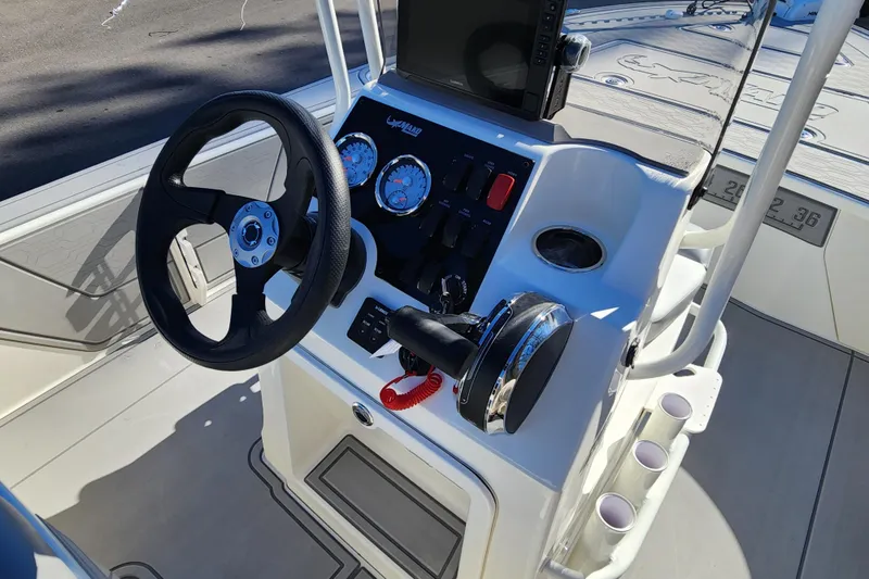 Slide: The Image of 2026 Mako 18 Pro Skiff boat console with steering wheel and control panel. - 11