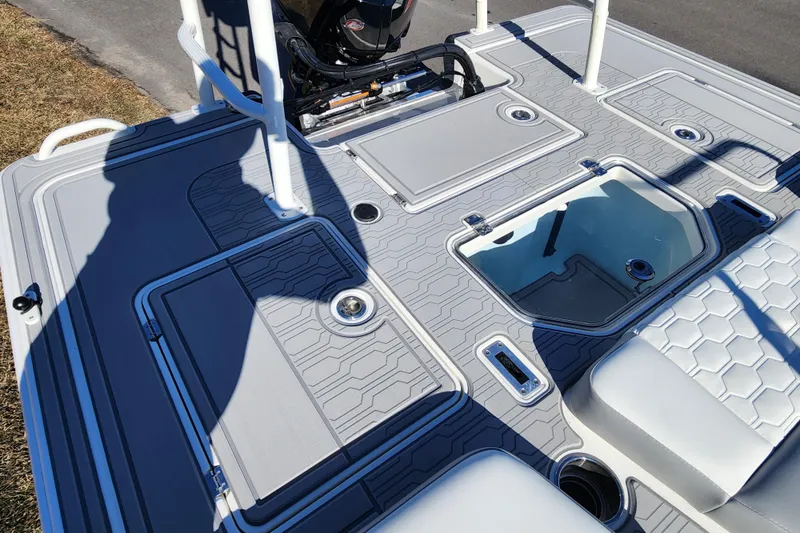 Slide: The Image of 2026 Mako 18 Pro Skiff boat deck with storage compartments and seating. - 14