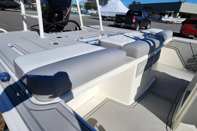 Slide: The Image of 2026 Mako 18 Pro Skiff interior with cushioned seating and storage compartments. - 15