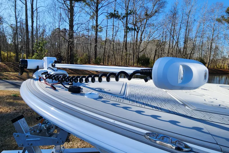 Slide: The Image of 2026 Mako 18 Pro Skiff boat with trolling motor on a sunny day by the lake. - 7