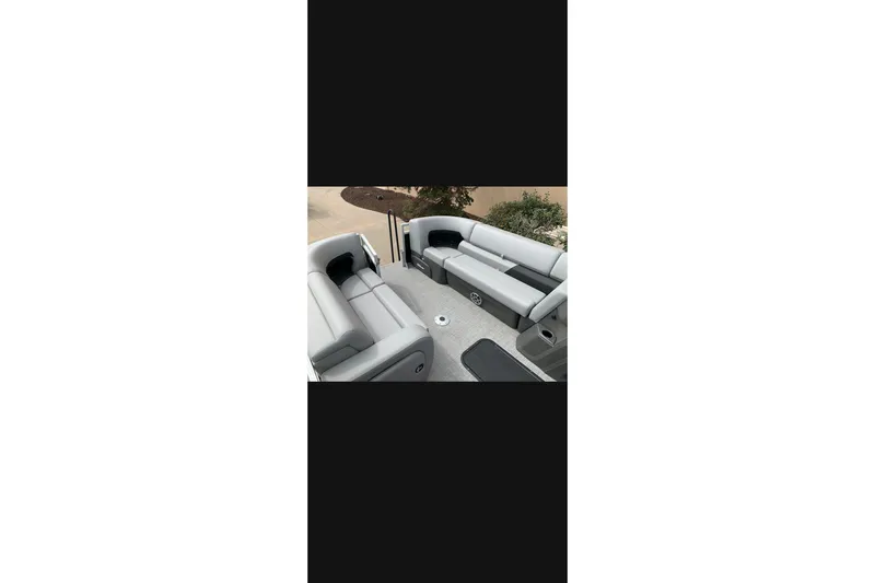 The Image of Interior view of 2026 Sun Tracker SportFish 22 XP3 pontoon boat with gray seating. - 0