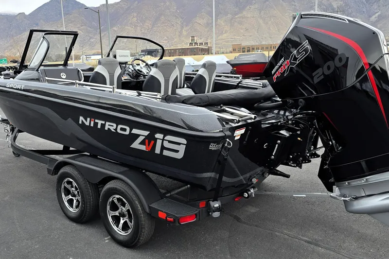 Slide: The Image of 2026 Nitro ZV19 Sport Pro boat with Mercury 200 engine on trailer, mountain backdrop. - 63